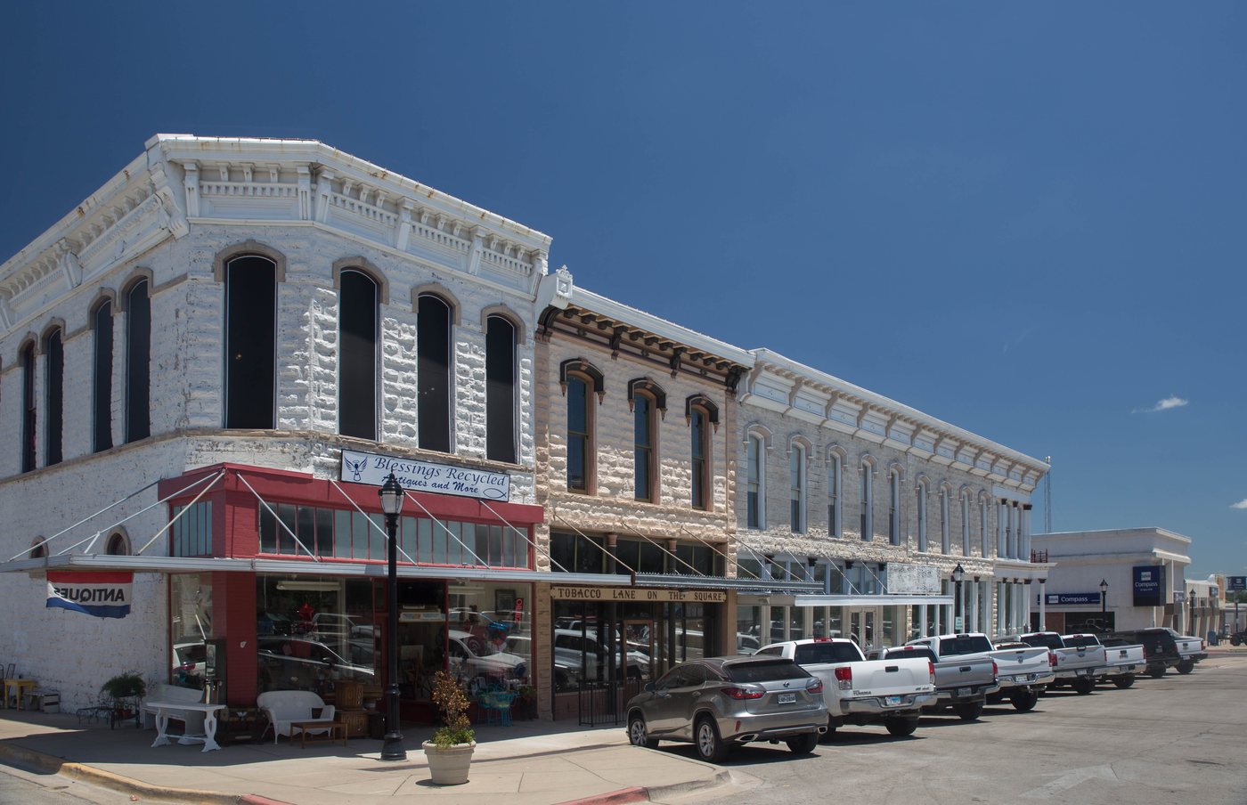 Two-story brick storefronts along a street in the Weatherford Downtown Historic District, Texas.